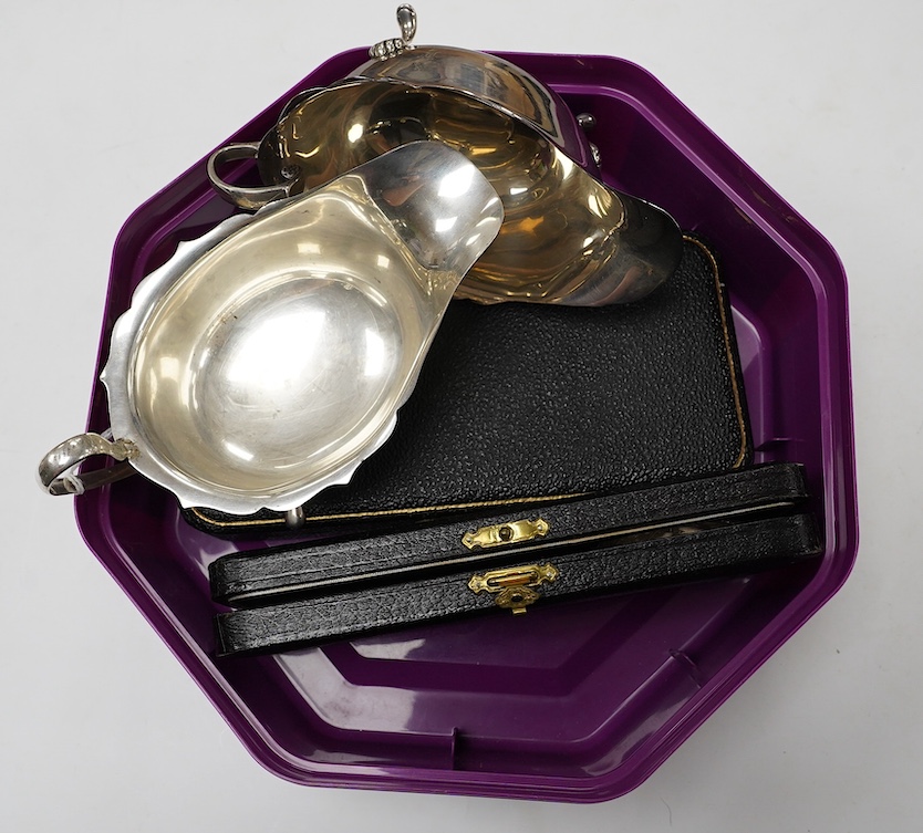 Two George V silver sauceboats and two cased flatware sets. Condition - fair